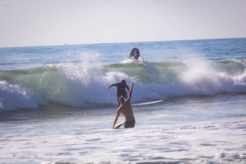 Three surfers in ocean