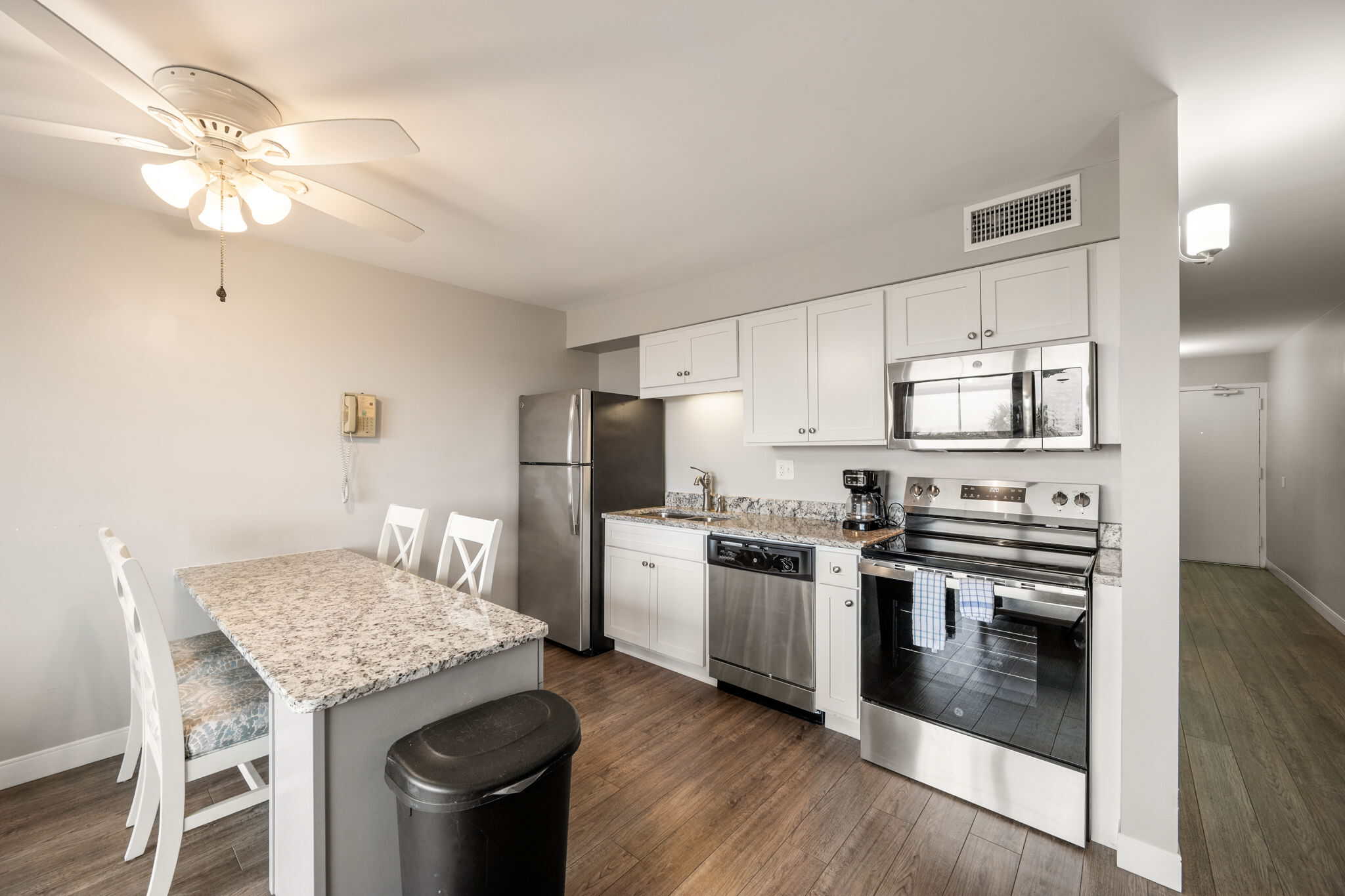 Interior full kitchen suite with updated appliances and breakfast bar